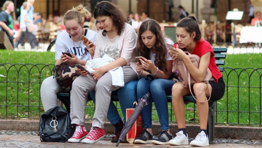 Teenagers looking at their smartphones
