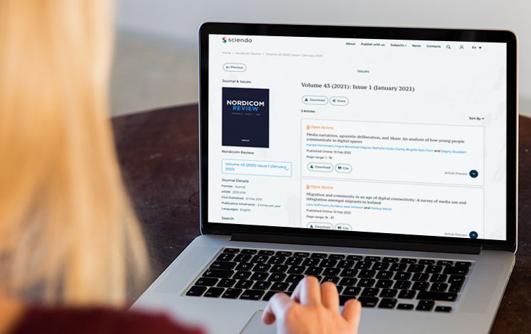 Person reading Nordicom Review on a computer.