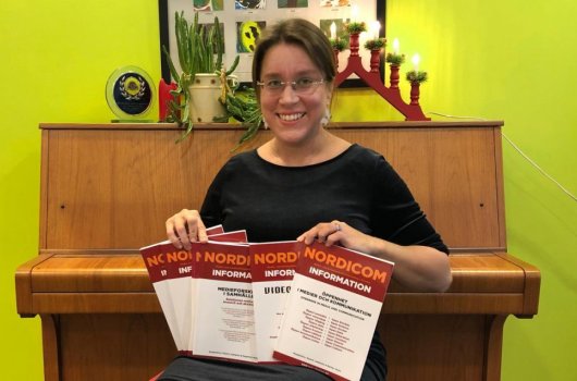 Maarit Jaakkola with the latest issue of Nordicom Information