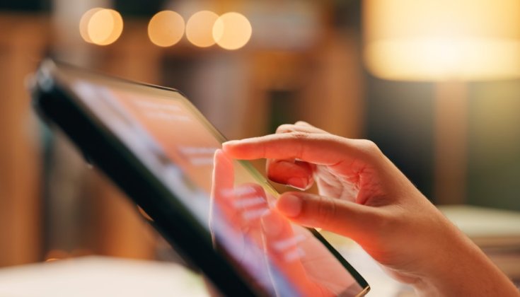 Hand som rör vid en Ipad. 